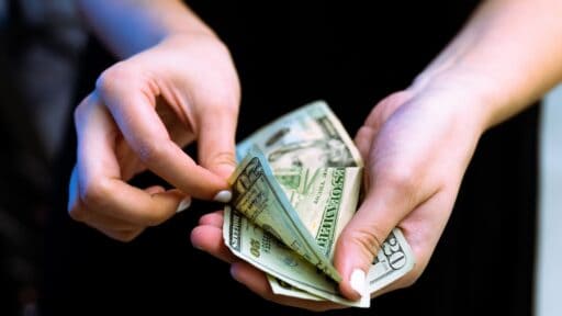 a persons hands counting money