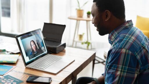 Man sitting looking at a computer