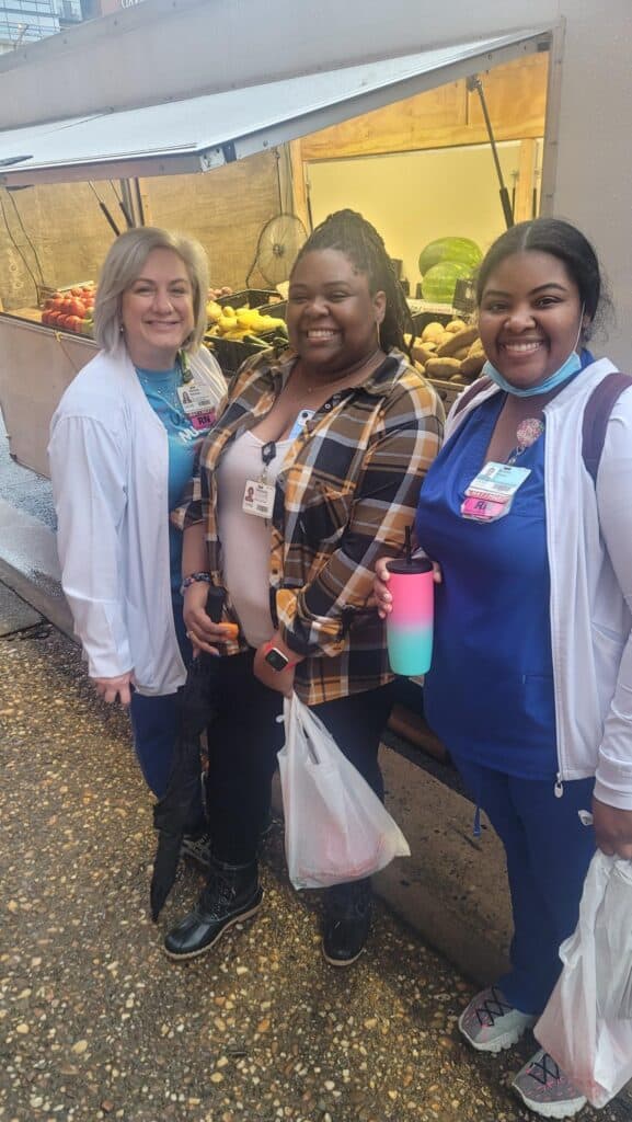 3 nurses stand in front of Carpenter's Produce