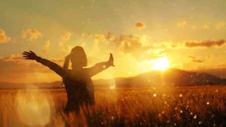 Woman embracing sunset