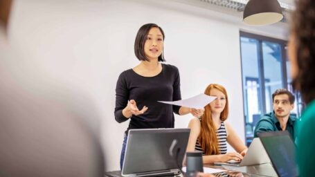 Woman speaking to colleagues